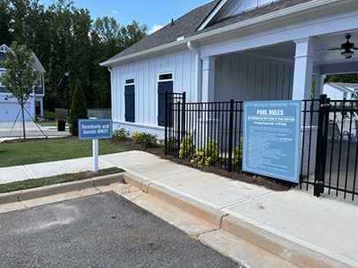 Blue pool rules sign and residents-only notice at Shoals Crossing subdivision swimming pool in Georgia.