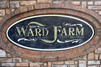 before power wash, clean, and repaint. Ward Farm neighborhood entrance monument sign with stone and brick masonry in Powder Springs, GA.