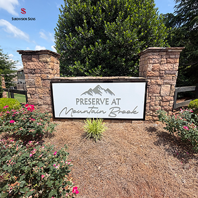 Refurbished neighborhood monument sign for Preserve at Mountain Brook featuring a modern aluminum panel mounted between stone columns in Metro Atlanta.
