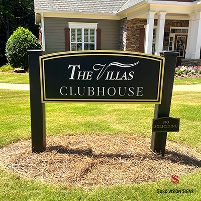 Post and panel clubhouse sign for The Villas featuring a black and gold sign panel installed near the community clubhouse in Dallas, Georgia.