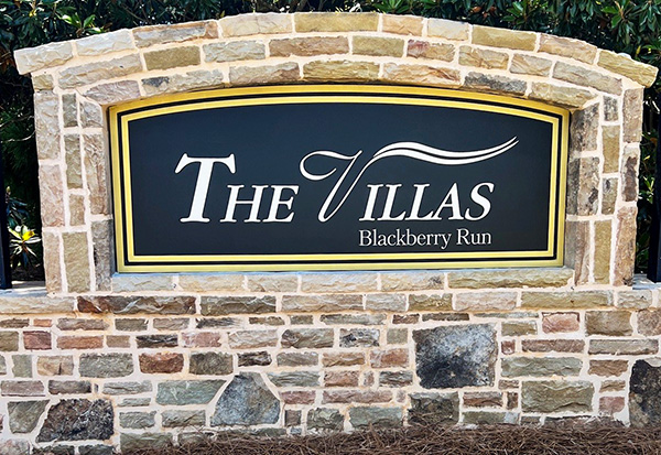Restored neighborhood monument sign after professional repainting and color restoration.