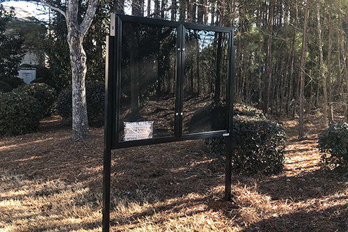 Black aluminum community reader board with locking display case installed in Marietta, Georgia.