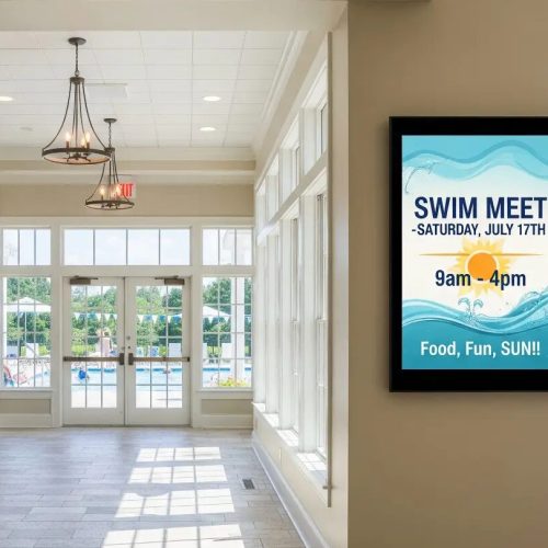 Indoor digital bulletin board — swim-meet notice in HOA clubhouse lobby (Metro Atlanta)