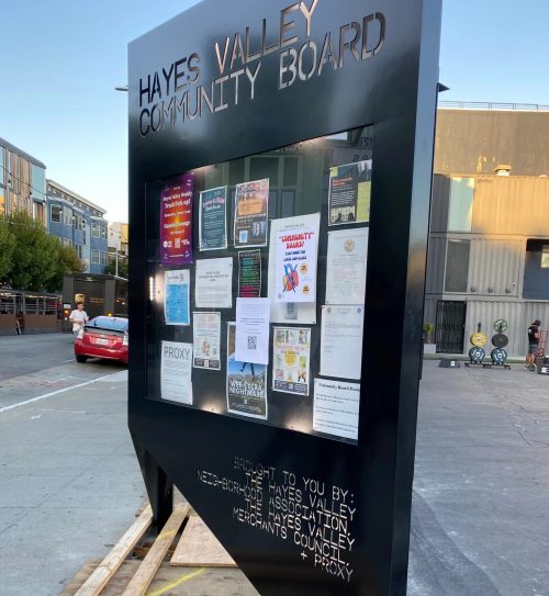 Black metal community bulletin board kiosk with laser-cut header and enclosed notice case for Metro Atlanta, GA.